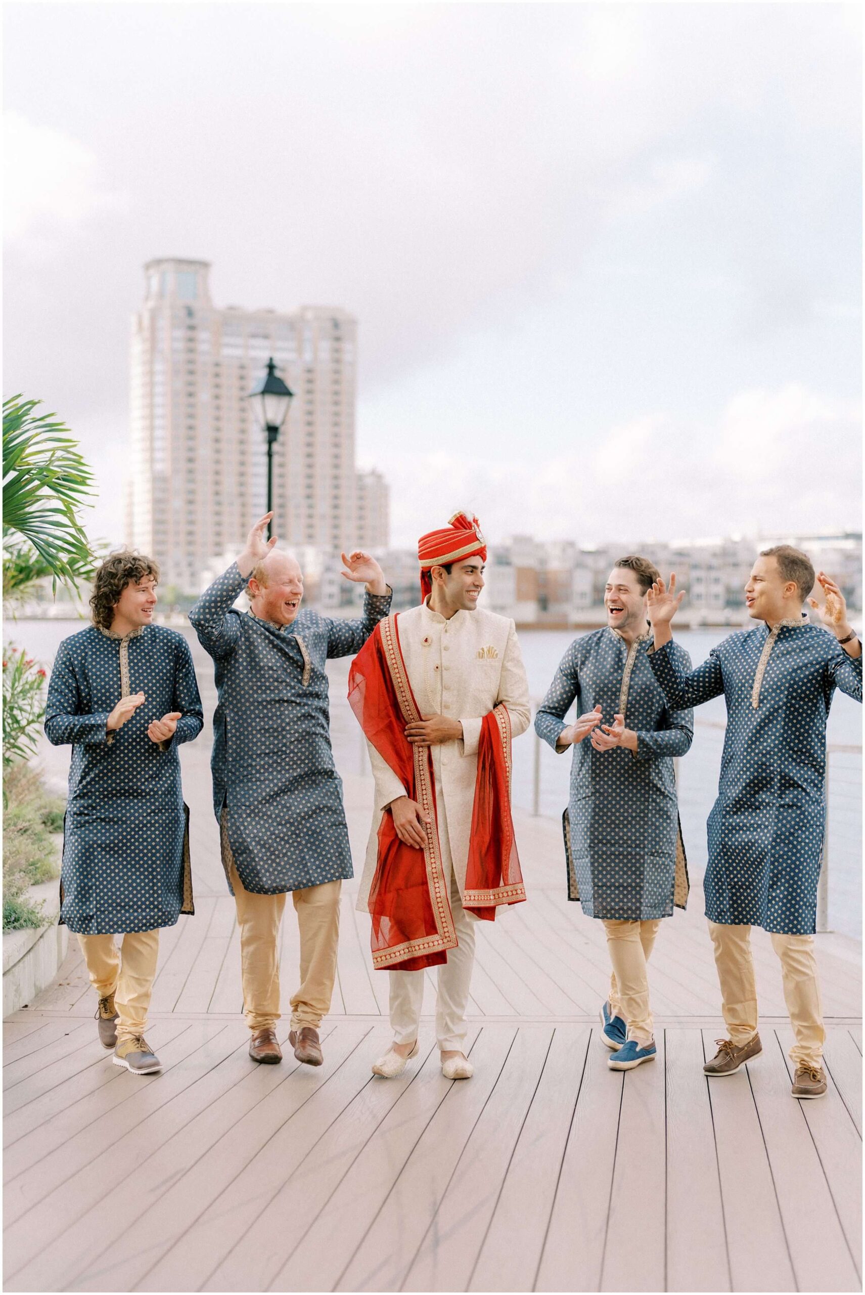 Baraat wedding festivities in the Inner Harbor of Baltimore. Photographed by multicultural wedding photographer Winnie Dora Photography.